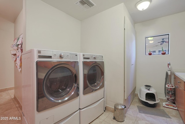 washroom with light tile patterned flooring and washer and dryer