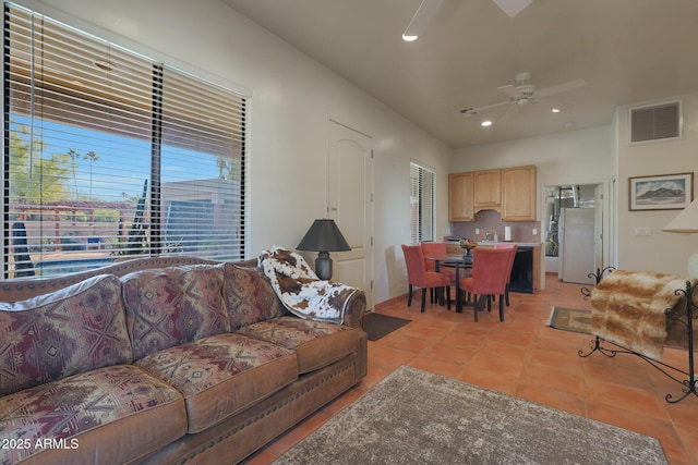 tiled living room featuring ceiling fan