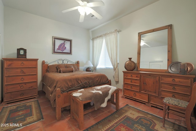 bedroom with ceiling fan and light tile patterned floors