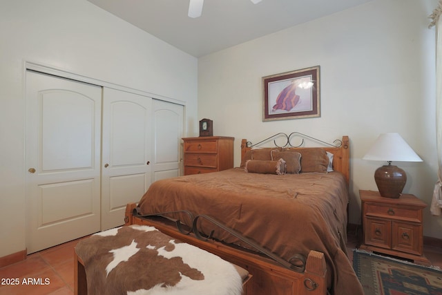 bedroom featuring ceiling fan, a closet, and tile patterned floors