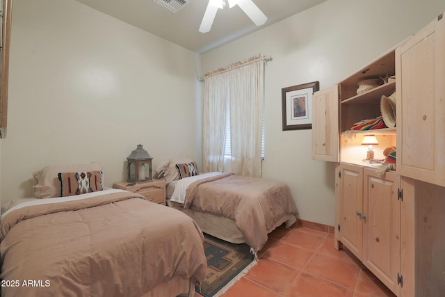 tiled bedroom featuring ceiling fan