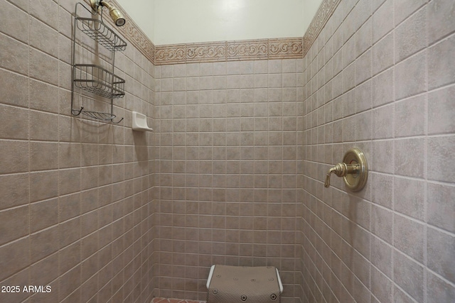 bathroom with tiled shower