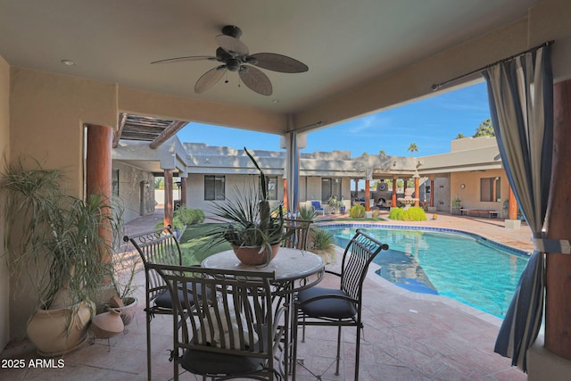 view of swimming pool with ceiling fan and a patio area