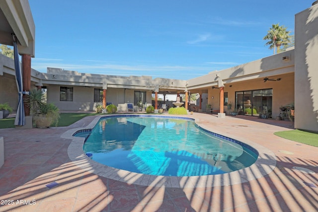 view of pool with ceiling fan and a patio