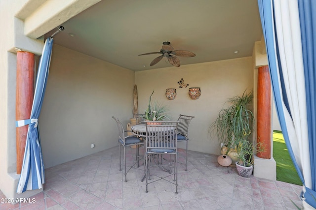 view of patio featuring ceiling fan