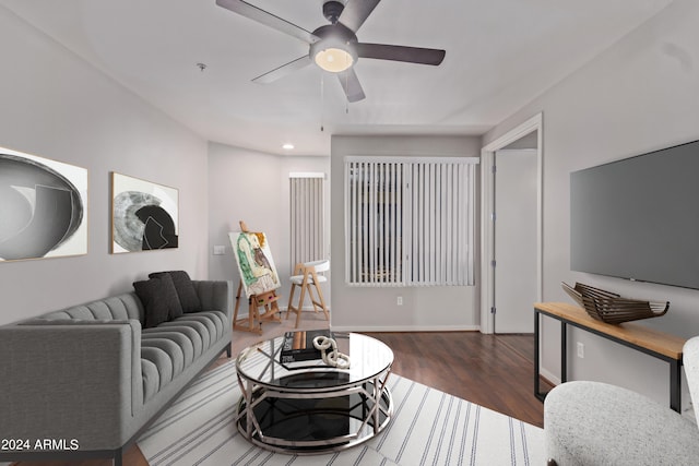 living room with dark hardwood / wood-style floors and ceiling fan