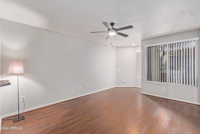 unfurnished room featuring ceiling fan and dark hardwood / wood-style flooring