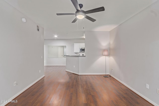 unfurnished living room with ceiling fan and dark hardwood / wood-style floors