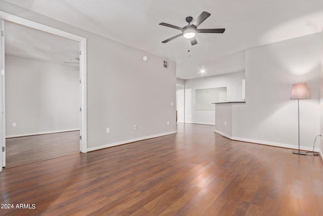 unfurnished living room with ceiling fan and dark hardwood / wood-style floors