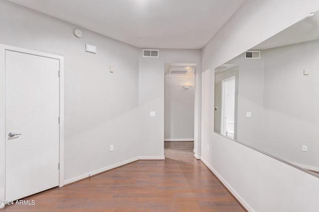 unfurnished room with dark wood-type flooring