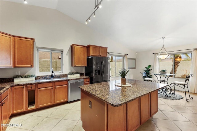 2923 N 63rd St, Mesa, AZ 85215 - kitchen featuring light tile patterned floors, black refrigerator with ice dispenser, stainless steel dishwasher, brown cabinetry, and a sink
