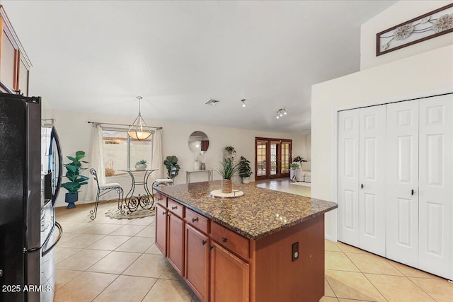 2923 N 63rd St, Mesa, AZ 85215 - kitchen featuring a wealth of natural light, freestanding refrigerator, light tile patterned flooring, and a kitchen island