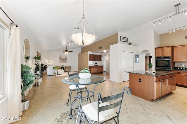 2923 N 63rd St, Mesa, AZ 85215 - dining area with light tile patterned floors, visible vents, arched walkways, vaulted ceiling, and track lighting