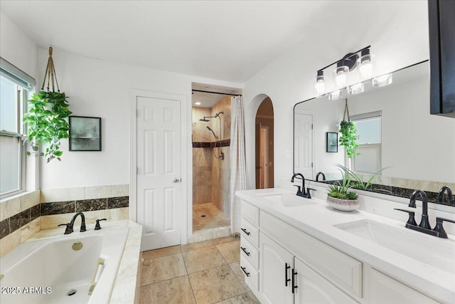 2923 N 63rd St, Mesa, AZ 85215 - bathroom featuring a garden tub, double vanity, a sink, and a shower stall