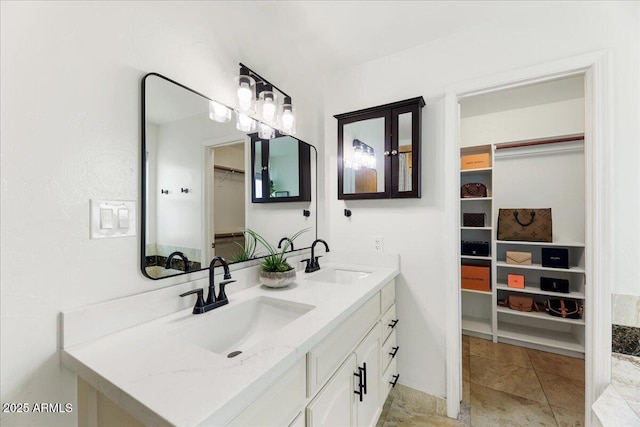 2923 N 63rd St, Mesa, AZ 85215 - bathroom featuring a walk in closet, a sink, and double vanity