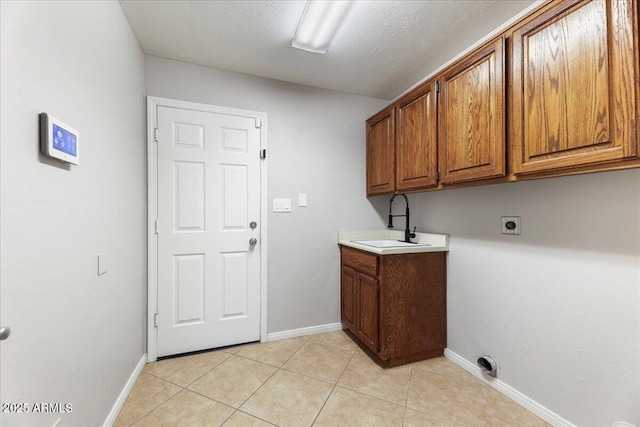 2923 N 63rd St, Mesa, AZ 85215 - laundry area featuring light tile patterned floors, cabinet space, a sink, electric dryer hookup, and baseboards