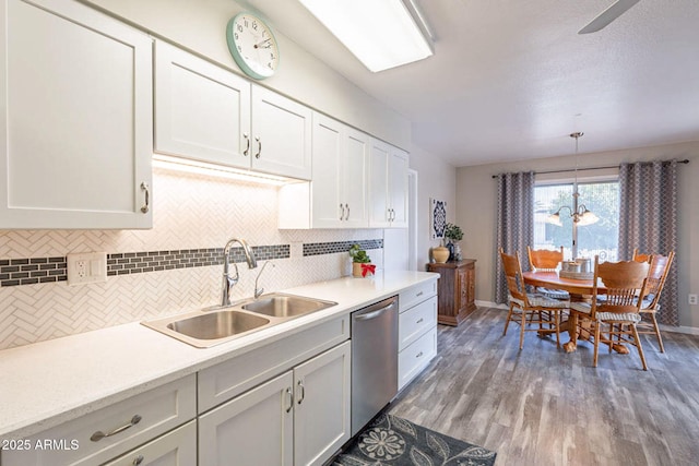 kitchen featuring white cabinetry, dishwasher, sink, and pendant lighting