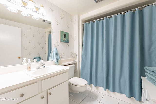 bathroom with tile patterned flooring, vanity, and toilet