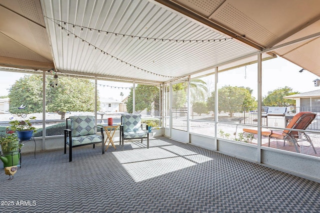 sunroom / solarium featuring rail lighting