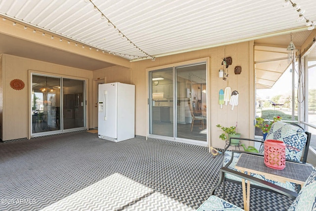 sunroom featuring rail lighting