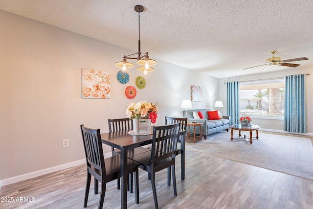 dining area featuring hardwood / wood-style floors, a textured ceiling, and ceiling fan