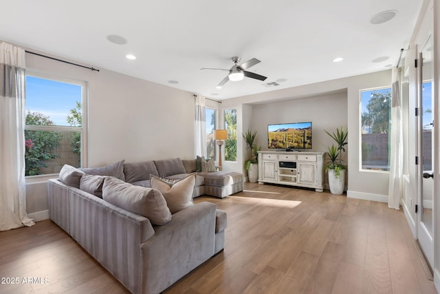 living area featuring visible vents, recessed lighting, baseboards, and light wood-style floors