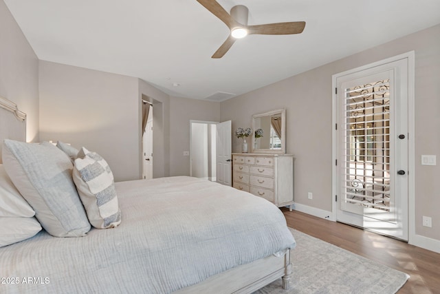 bedroom with ceiling fan, baseboards, and wood finished floors