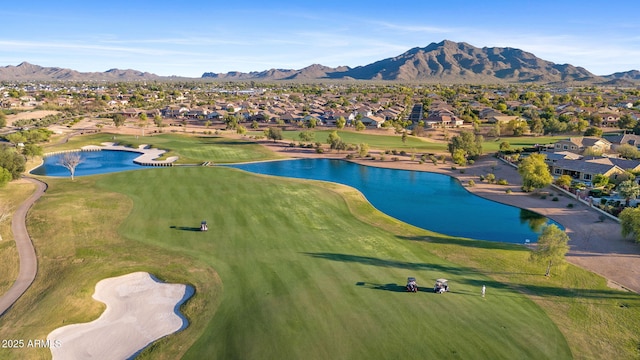 aerial view with a residential view, a water and mountain view, and view of golf course