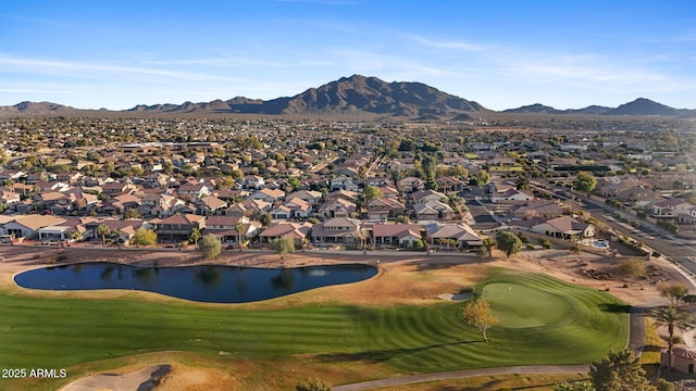 drone / aerial view with a residential view, a water and mountain view, and view of golf course