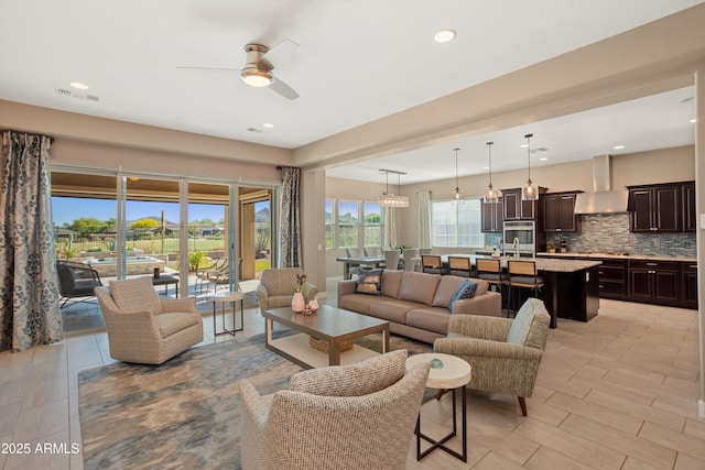 living room with visible vents, ceiling fan, and recessed lighting