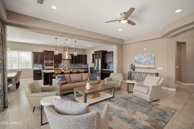 living room featuring visible vents, ceiling fan, recessed lighting, and baseboards