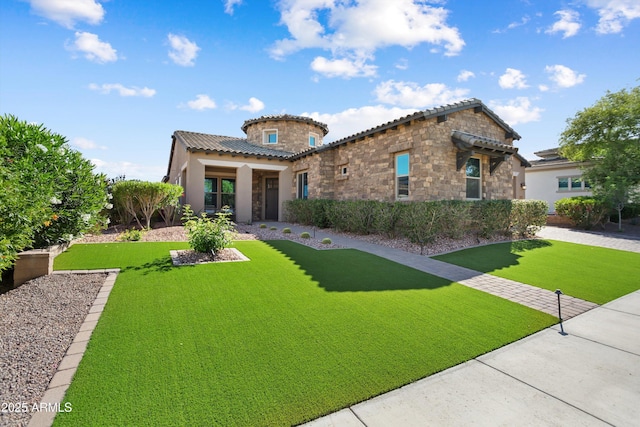 mediterranean / spanish home with stucco siding, a front yard, a tile roof, and stone siding