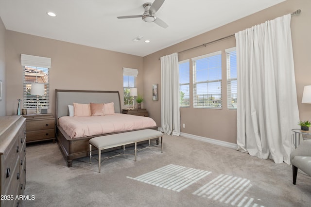 bedroom featuring baseboards, recessed lighting, multiple windows, and light colored carpet