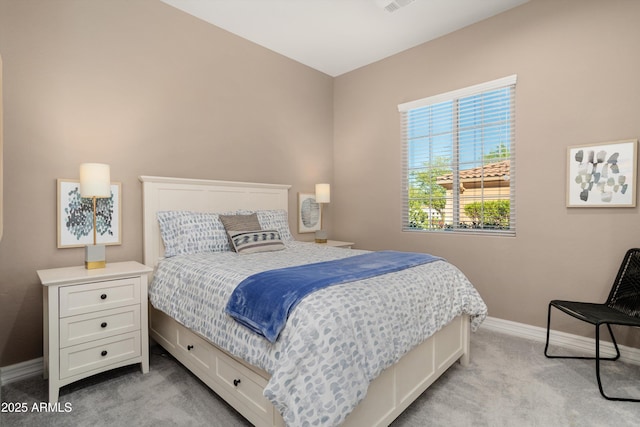 bedroom with baseboards and light carpet