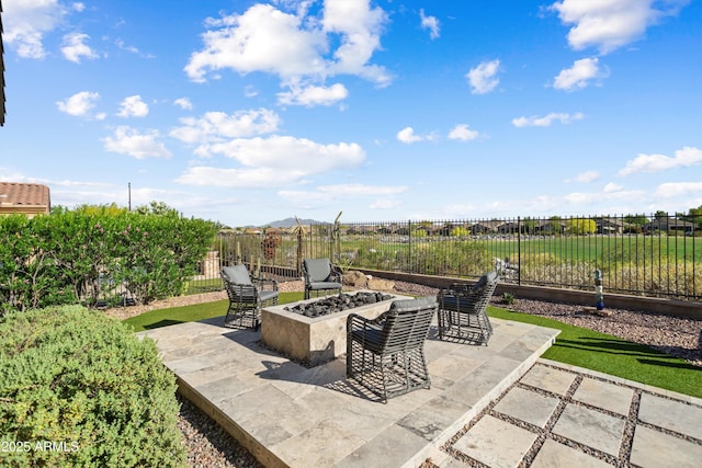 view of patio / terrace with a fire pit and fence
