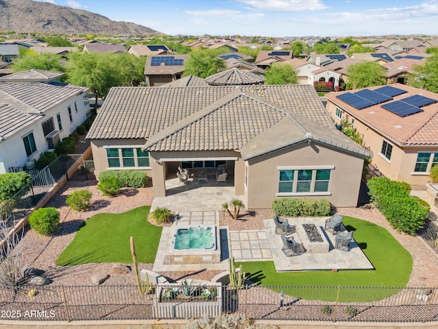 rear view of house with stucco siding, a patio, a residential view, and a fenced front yard