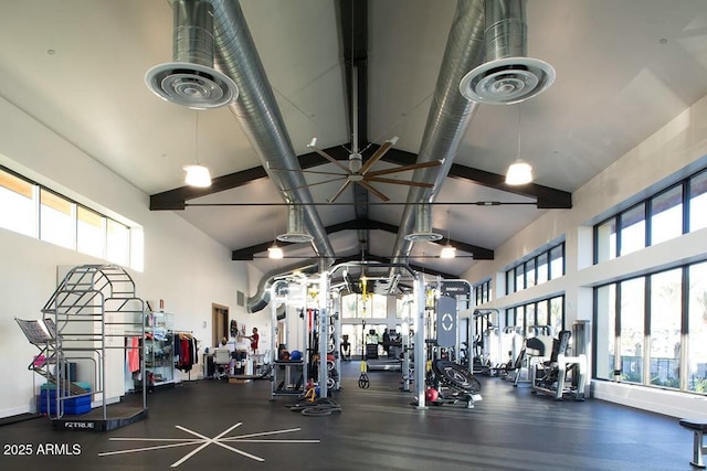 gym featuring visible vents and high vaulted ceiling