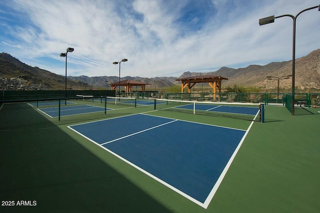 view of sport court with a mountain view, a gazebo, and fence