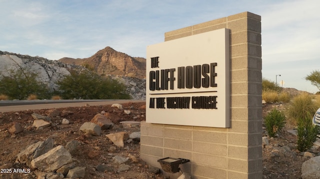 community sign with a mountain view