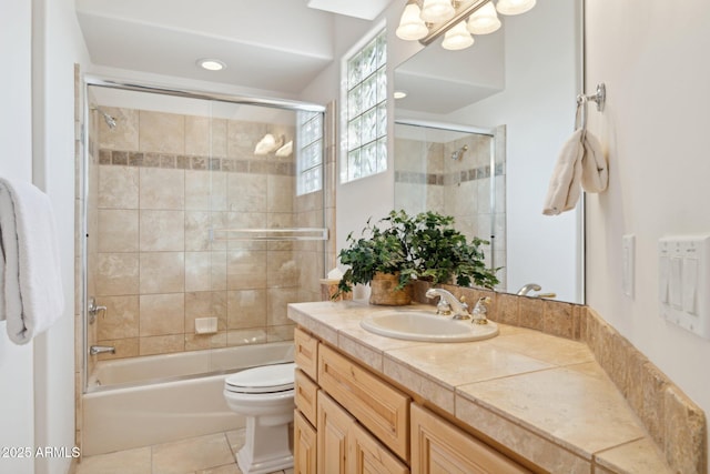 full bath with toilet, shower / bath combination with glass door, tile patterned flooring, and vanity