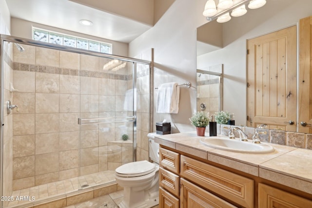 bathroom with toilet, a stall shower, and vanity