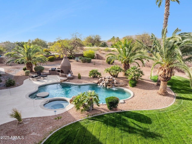 outdoor pool with an in ground hot tub, a yard, and a patio