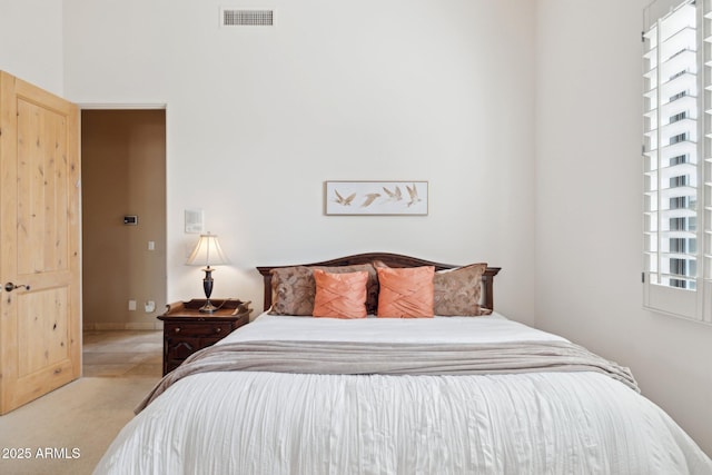 bedroom with visible vents and carpet flooring