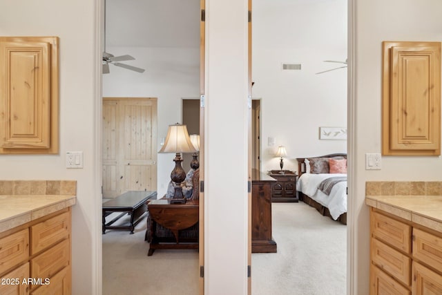 bedroom featuring visible vents and light colored carpet