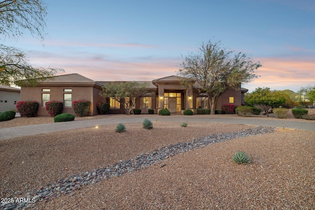 view of front of home with driveway and stucco siding