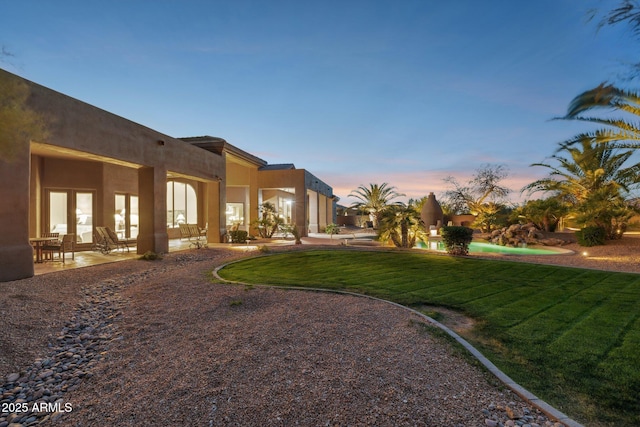 yard at dusk with a patio