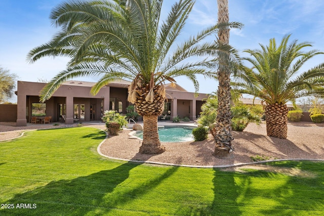 view of pool featuring a patio area and a yard