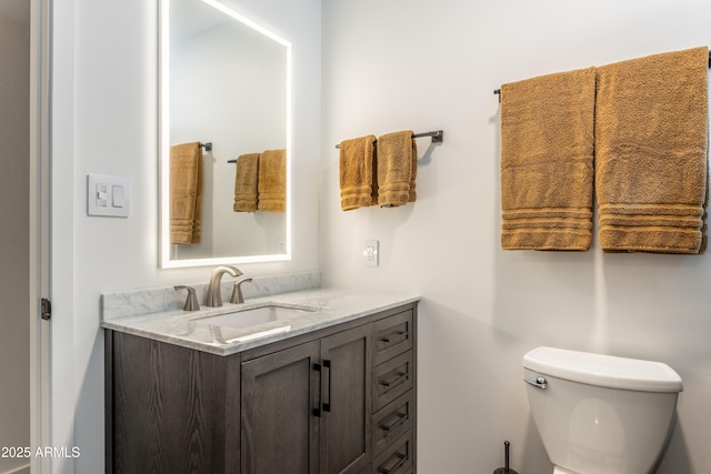 half bathroom with toilet and vanity