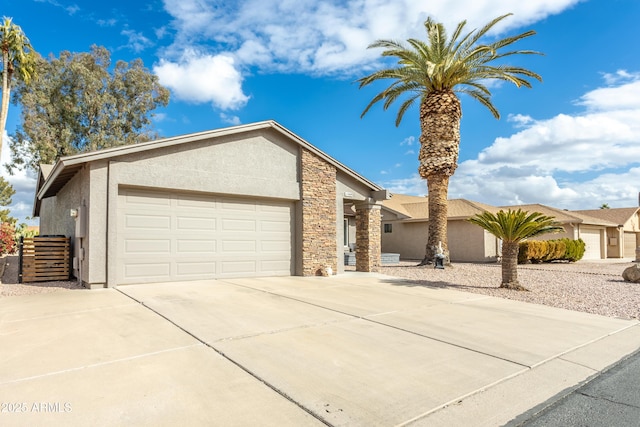 view of front facade featuring a garage, driveway, stone siding, and stucco siding