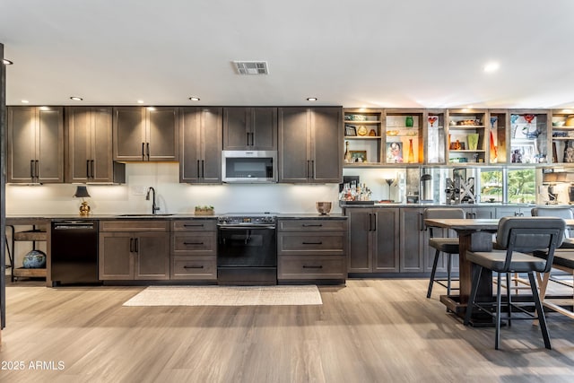 kitchen featuring electric stove, dishwasher, sink, and light hardwood / wood-style flooring